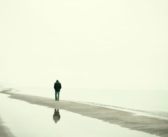 Man walking on beach in winter